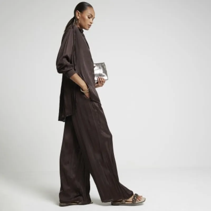 Brown satin crinkle trousers sold by River Island