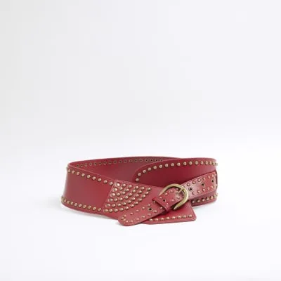 Red studded wide belt sold by River Island