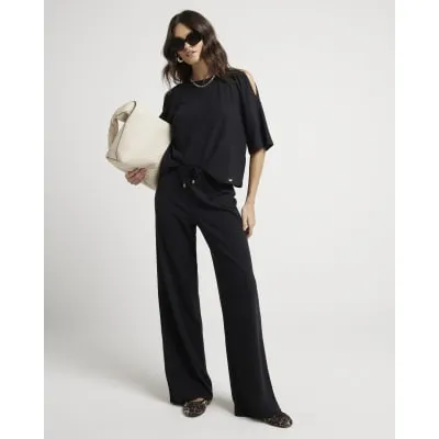 Black textured wide leg trousers sold by River Island