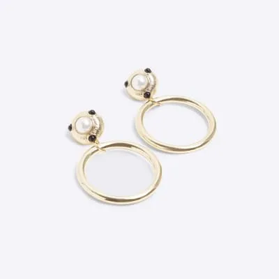 Gold diamante long drop earrings sold by River Island