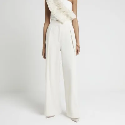 Cream pleated wide leg trousers sold by River Island