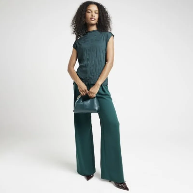 Green crinkle vest top sold by River Island