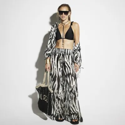Black zebra print shirred beach trousers sold by River Island