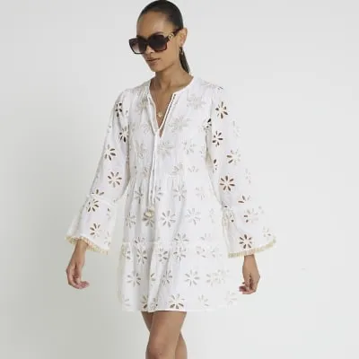 Cream broderie smock mini dress sold by River Island
