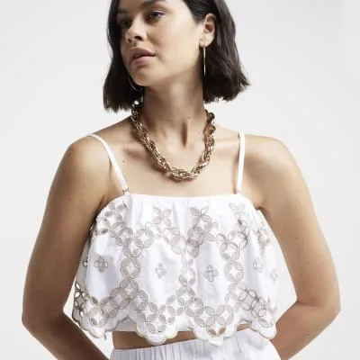 White cropped broderie cami top sold by River Island