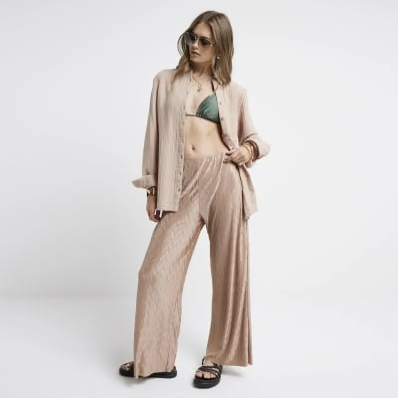Rose gold plisse wave wide leg trousers sold by River Island