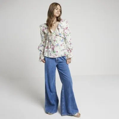 Cream floral frill blouse sold by River Island