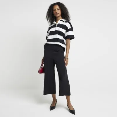 Black wide leg culottes sold by River Island