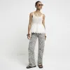 Cream crochet broderie trim vest top sold by River Island