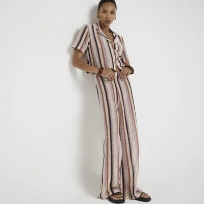 Pink crochet stripe wide leg trousers sold by River Island