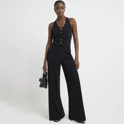 Black halter neck waistcoat jumpsuit sold by River Island