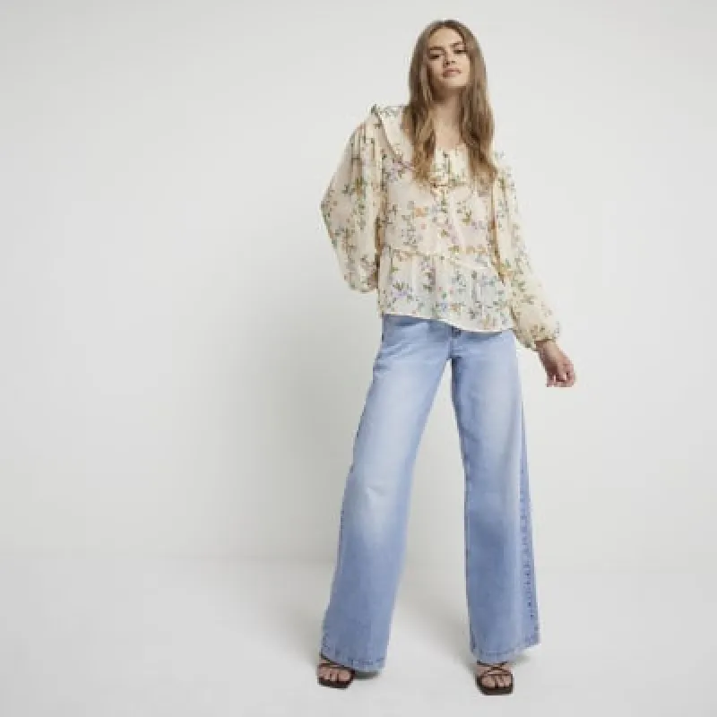 Cream floral frill tie front blouse sold by River Island