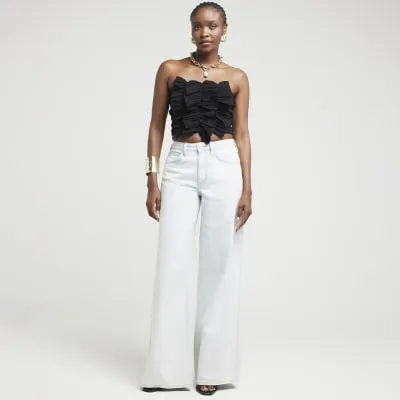 Black ruffled bandeau top sold by River Island