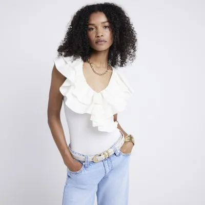 Cream frill detail bodysuit sold by River Island