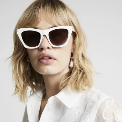 White pointed cateye sunglasses sold by River Island
