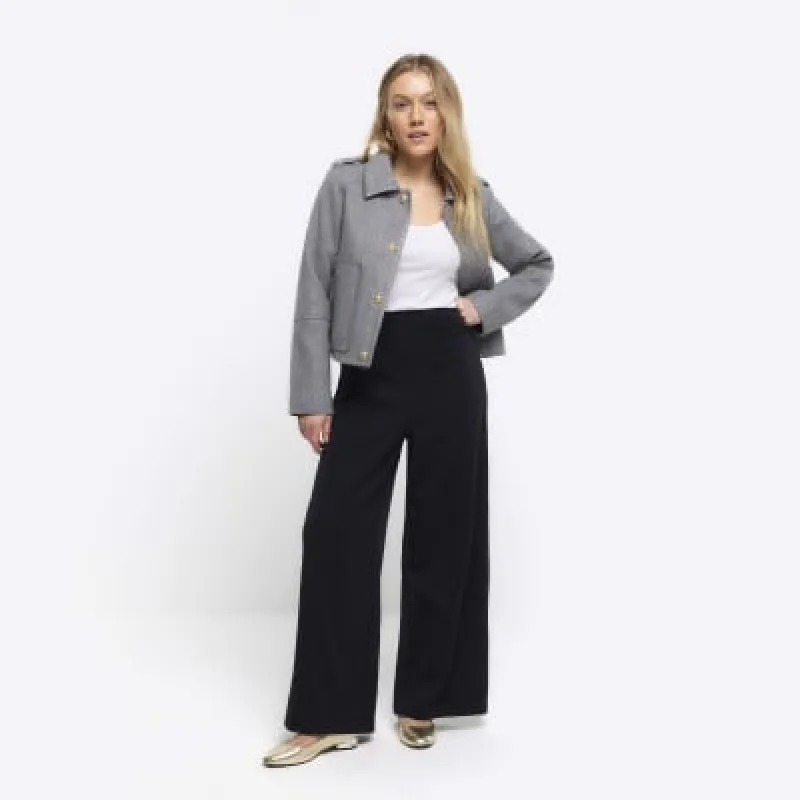 Petite black stitched wide leg trousers sold by River Island