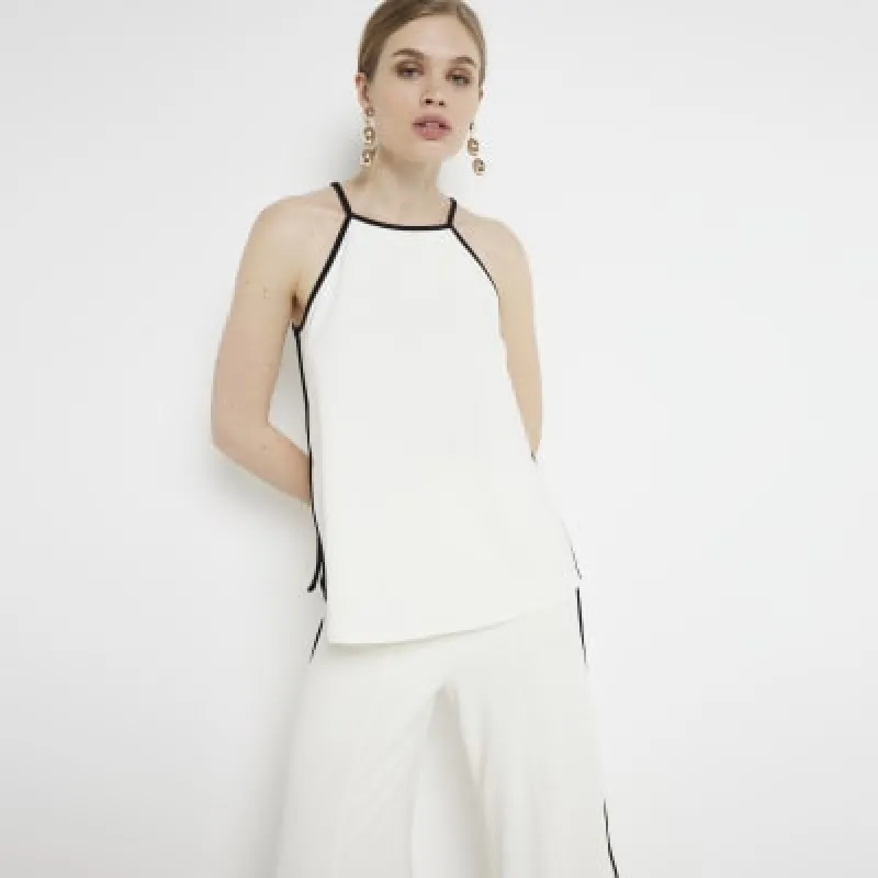 Cream taped cami top sold by River Island