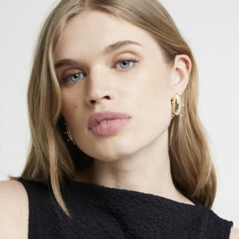 Gold pearl domed earrings sold by River Island