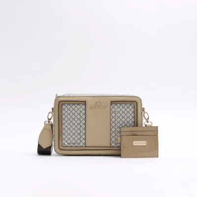 Brown RI monogram boxy cross body bag sold by River Island