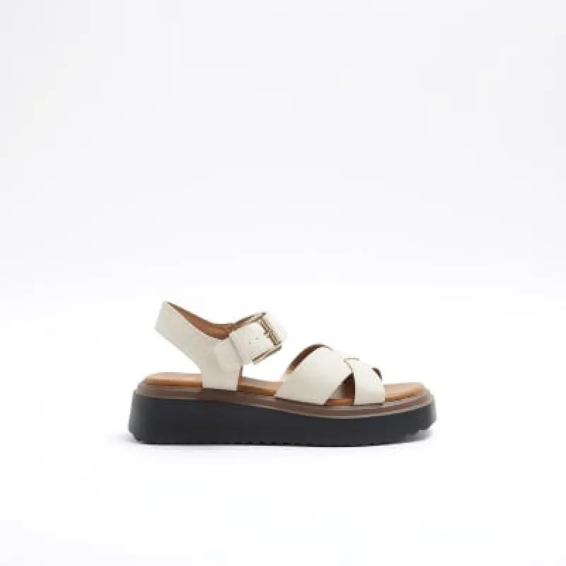 Beige cross strap flatform sandals sold by River Island