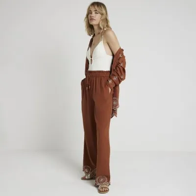 Rust linen blend broderie trousers sold by River Island
