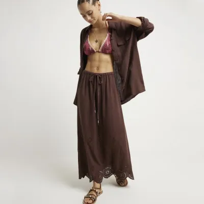 Brown linen blend broderie hem maxi skirt sold by River Island