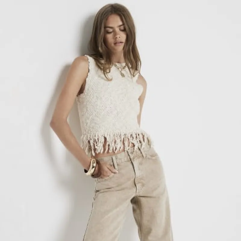 Cream knitted fringe vest top sold by River Island