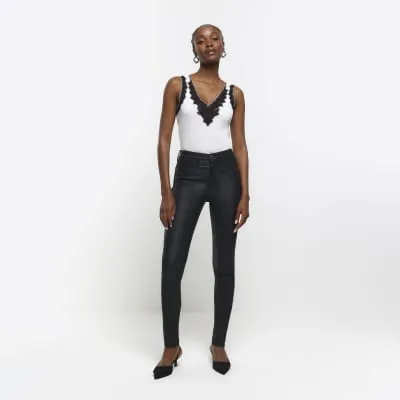 Black mid rise skinny coated jeans sold by River Island