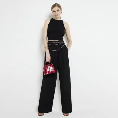 Black pleated wide leg trousers sold by River Island