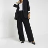 Petite black wide leg trousers sold by River Island