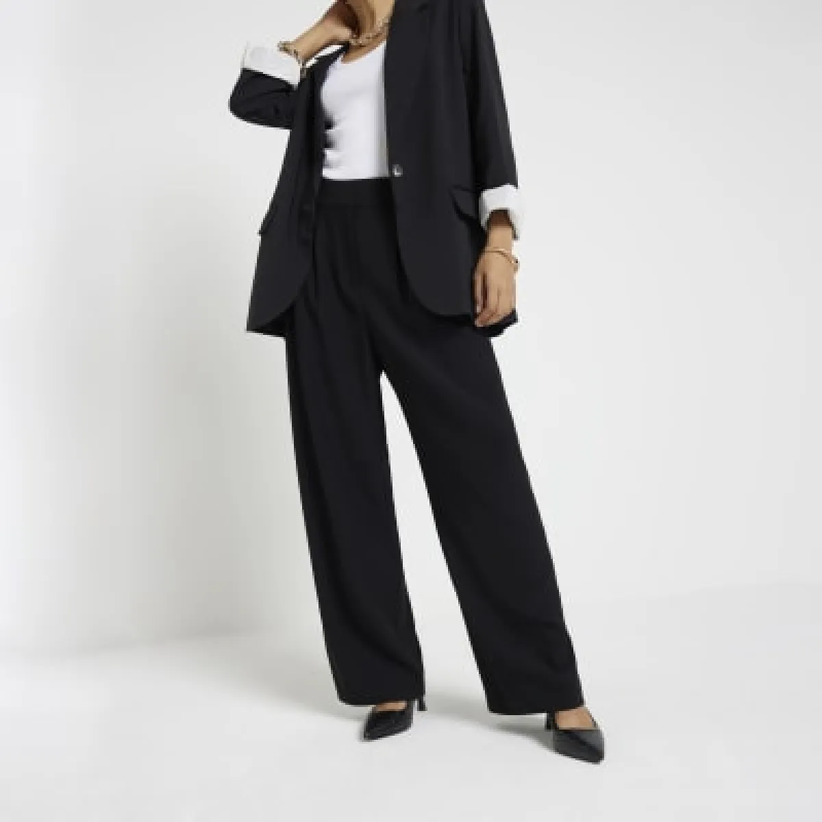 Petite black wide leg trousers sold by River Island