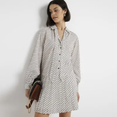 Cream spot pleated mini shirt dress sold by River Island
