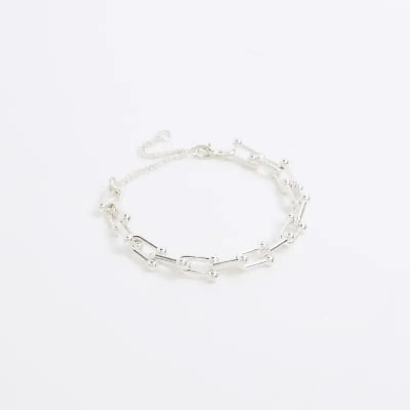 Silver chain link bracelet sold by River Island