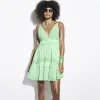 Green embellished plunge beach mini dress sold by River Island
