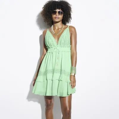 Green embellished plunge beach mini dress sold by River Island