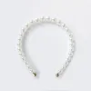 White pearl headband sold by River Island