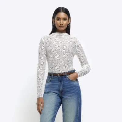 Cream lace long sleeve top sold by River Island