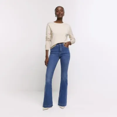 Blue high waisted tummy hold flare jeans sold by River Island