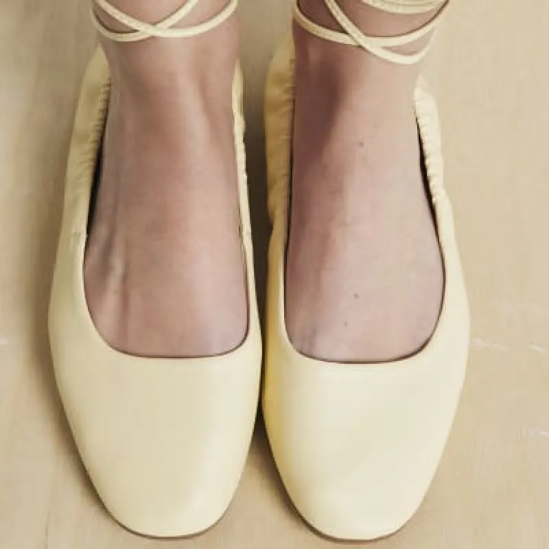 Yellow tie up ballet pumps sold by River Island