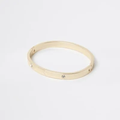 Gold stainless steel heart cuff bracelet sold by River Island