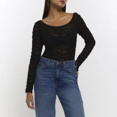 Black lace long sleeve top sold by River Island