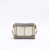 Cream RI monogram panel cross body bag sold by River Island