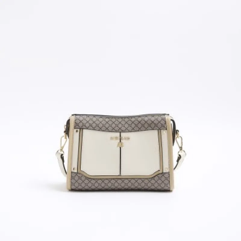 Cream RI monogram panel cross body bag sold by River Island