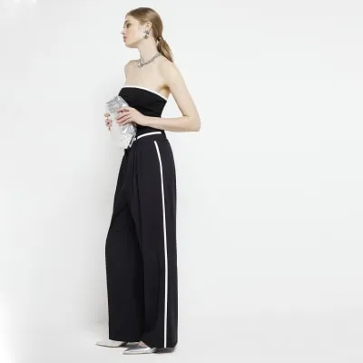 Black side stripe wide leg trousers sold by River Island