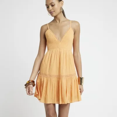 Orange shirred tiered beach mini dress sold by River Island