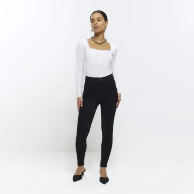 Petite black bum sculpt skinny jeans sold by River Island