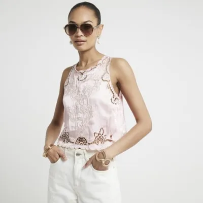 Pink broderie cut out tank top sold by River Island