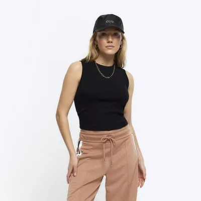 Petite black rib high neck tank top sold by River Island