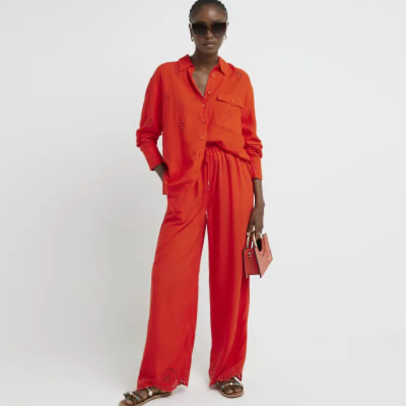 Red broderie linen blend trousers sold by River Island