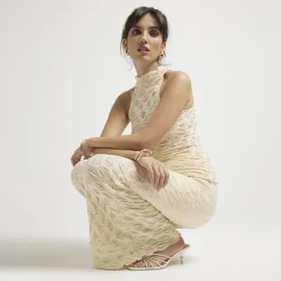 Cream textured halter neck top sold by River Island